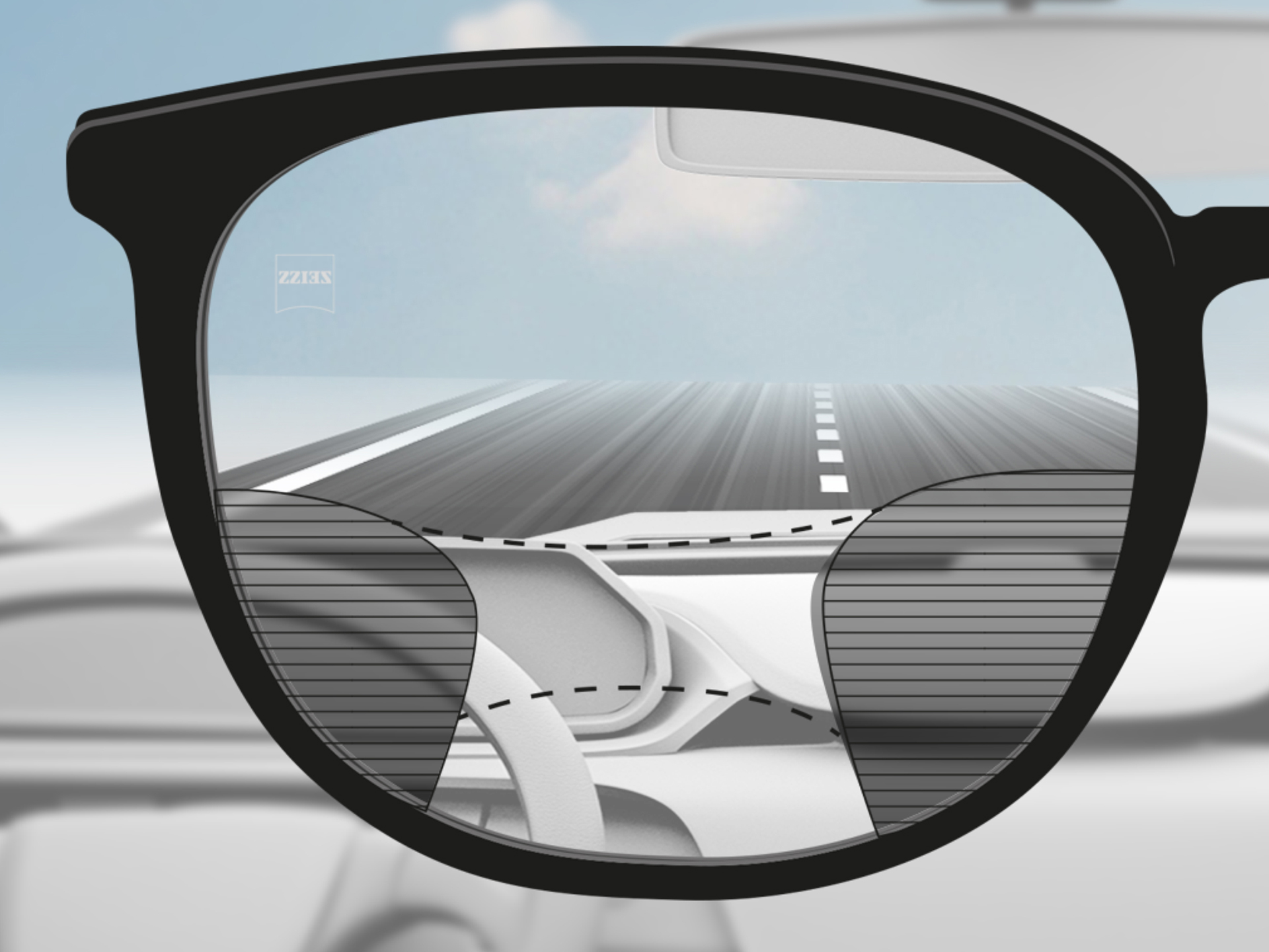Et billede med et syn igennem et ZEISS Progressive DriveSafe brilleglas: Synszonerne er tilpasset, så føreren har klare synszoner over vejen og på instrumentbordet.