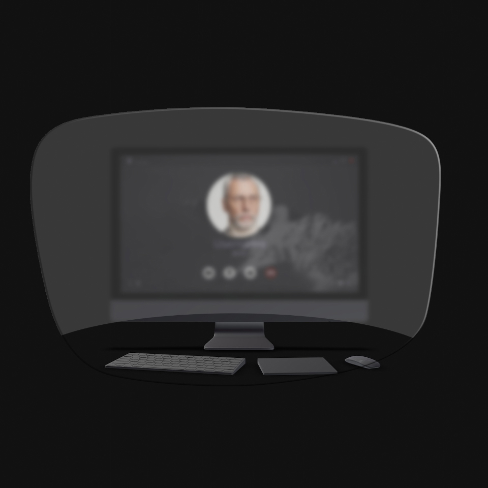 Synet af en stationær computer, et tastatur, en mus og en bog gennem en skematisk illustration af læsebriller viser at kun genstande, der er meget tæt på, kan ses tydeligt. Computerskærmen er sløret.