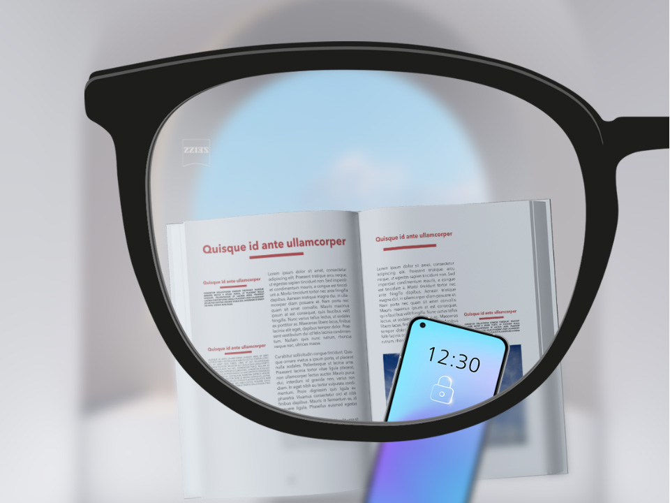 Et udsnit af et billede med ZEISS Single Vision SmartLife brilleglas med en smartphone, en bog og brilleglasset helt klart.